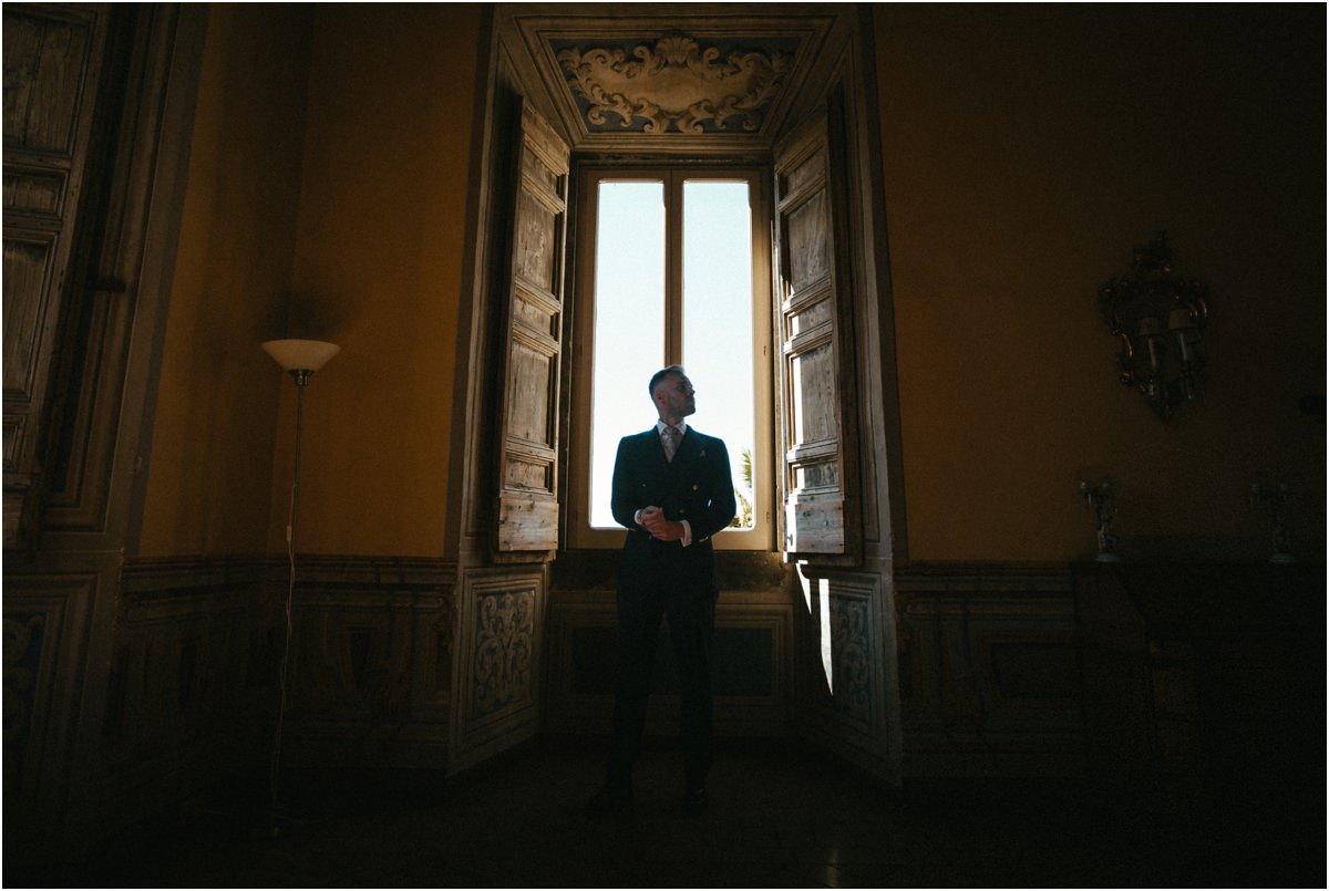 Groom Silhouette by the Window Silhouette of groom Angus standing in front of a tall window in a dark historic room of Villa Grazioli