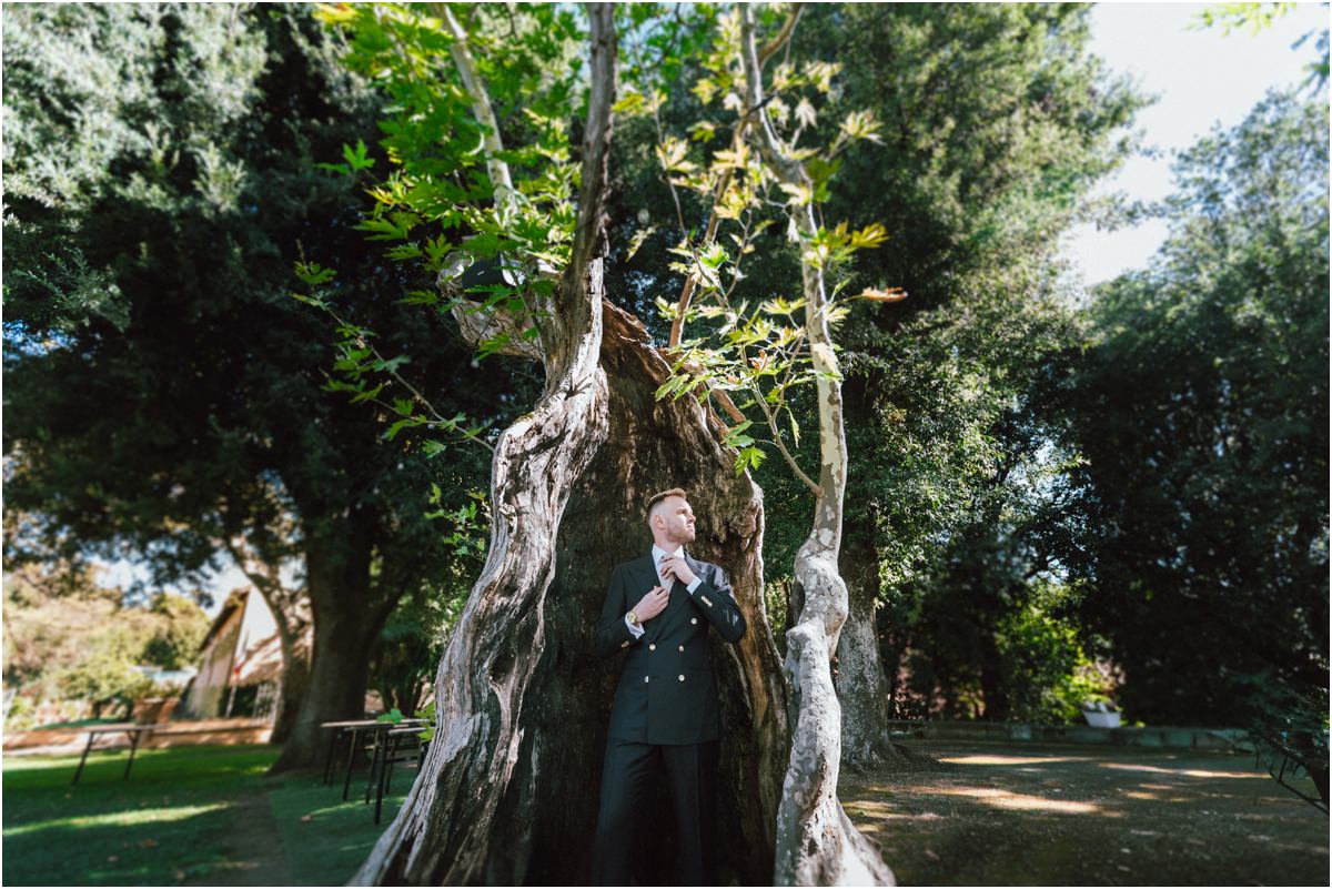 Groom Portrait Inside an Ancient Tree Trunk Groom Angus standing inside a large hollow tree trunk in the park of Villa Grazioli, Grottaferrata