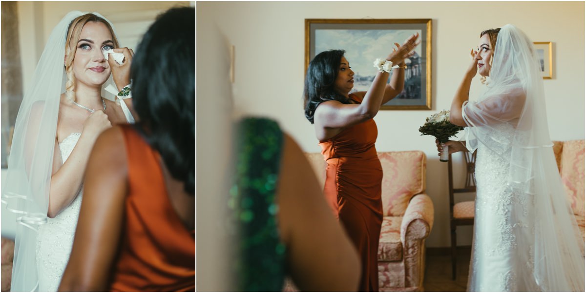 The Veil and the First Tears Bride Miriana wiping a tear after putting on her veil, with a bridesmaid in an orange dress beside her
