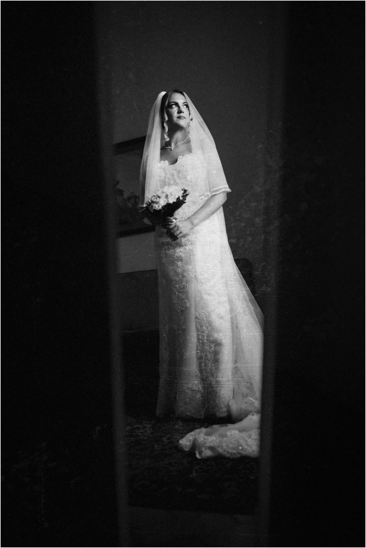 Bride Framed by a Door, Black and White Black and white full-length portrait of bride Miriana framed through a half-open door
