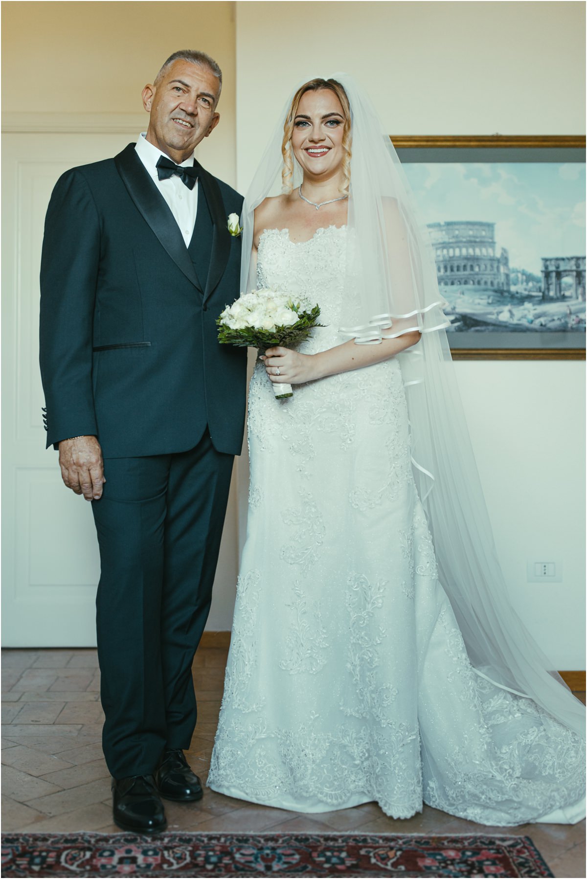 Bride with the Man Who Walks Her to the Ceremony Smiling bride Miriana with bouquet standing next to a man in a tuxedo before the ceremony