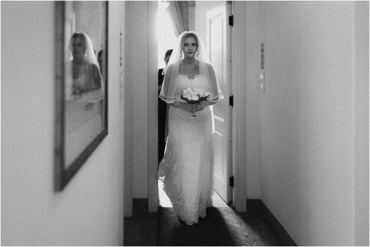 Bride Walking Out, Ready for the Ceremony Black and white photo of bride Miriana with veil and bouquet walking along a corridor towards the ceremony