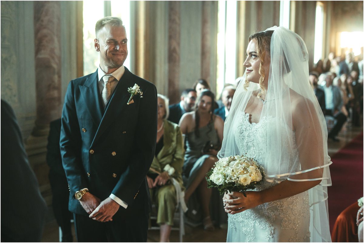 Groom Seeing the Bride for the First Time Groom Angus smiling as bride Miriana reaches him at the end of the aisle in the Pannini Gallery