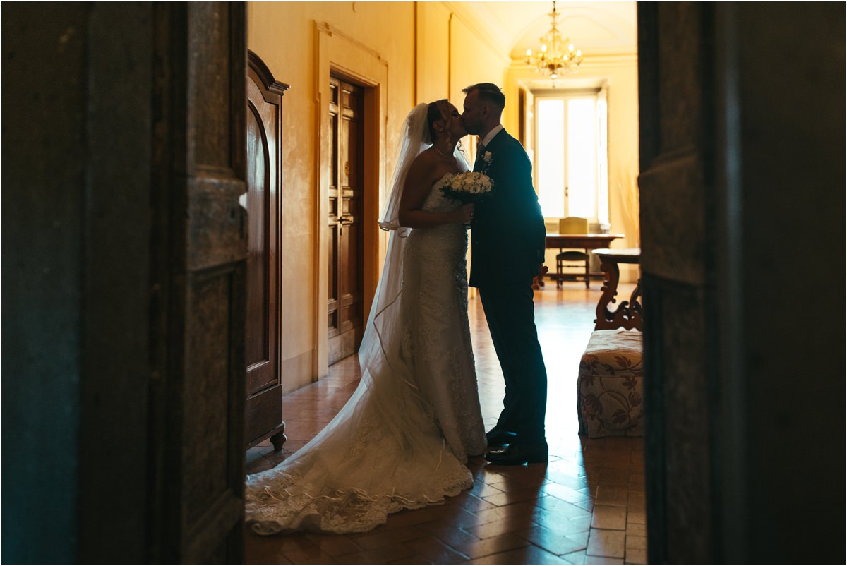 Newlyweds Kissing in a Doorway at Villa Grazioli Miriana and Angus kissing framed by a doorway in a historic room of Villa Grazioli