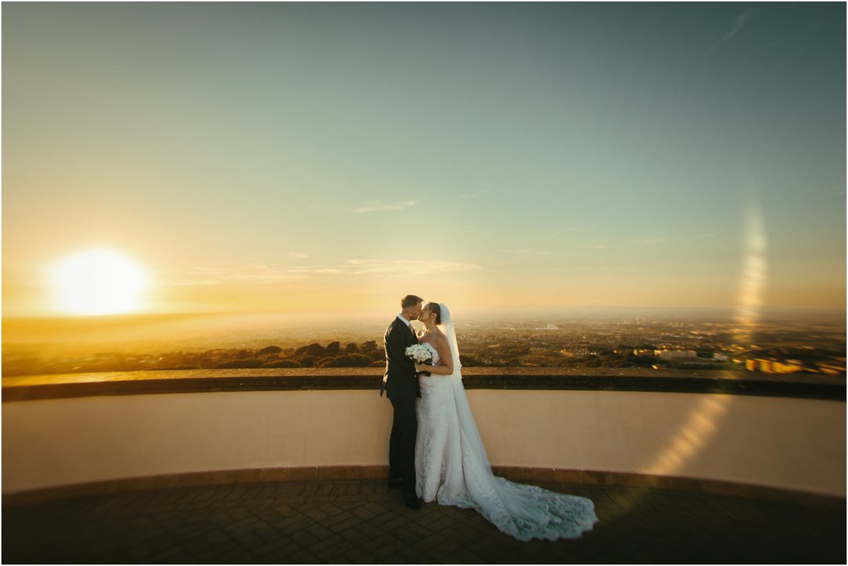 Couple Silhouette Against the Setting Sun Miriana and Angus kissing against the setting sun on the terrace of Villa Grazioli, with a warm lens flare