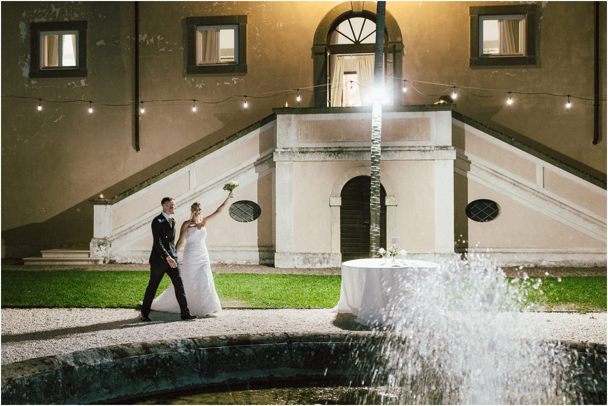 Newlyweds Entrance by the Fountain Miriana raising her bouquet as she and Angus make their entrance by the fountain of Villa Grazioli at night