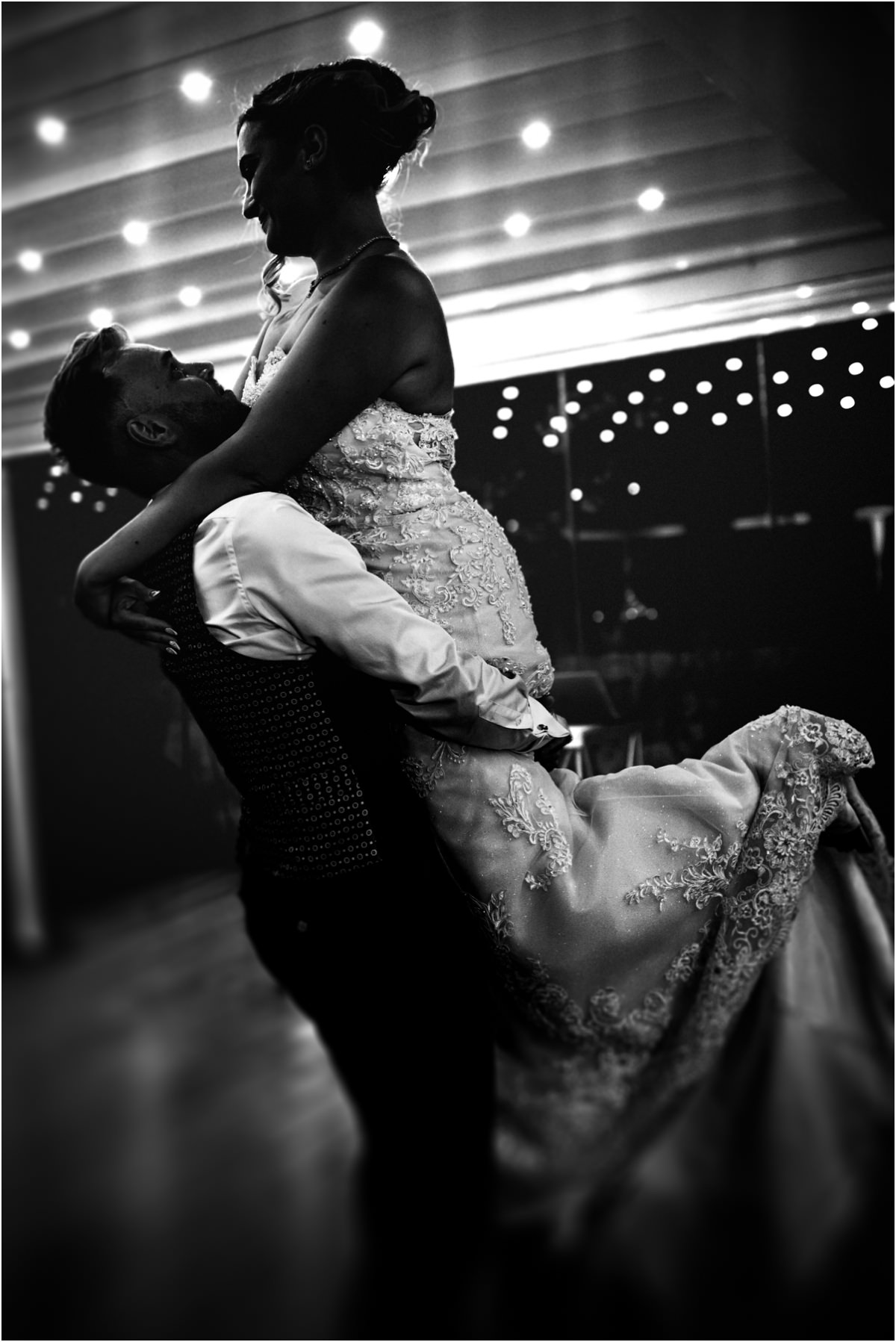 Groom Lifting the Bride, Black and White Black and white photo of Angus lifting Miriana high during their first dance