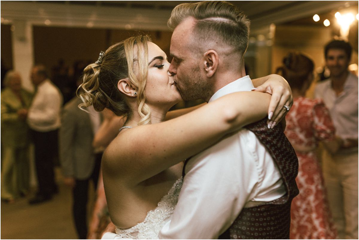 Kiss on the Dance Floor Miriana and Angus kissing in a tight embrace on the dance floor surrounded by guests