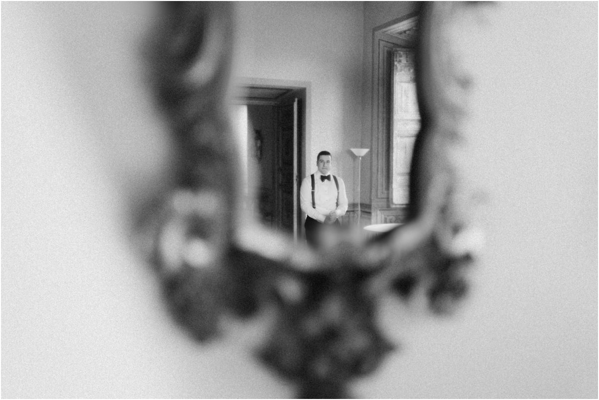 Groom Reflected in an Antique Mirror Black and white photo of groom Alessio reflected in an antique carved mirror at Villa Grazioli