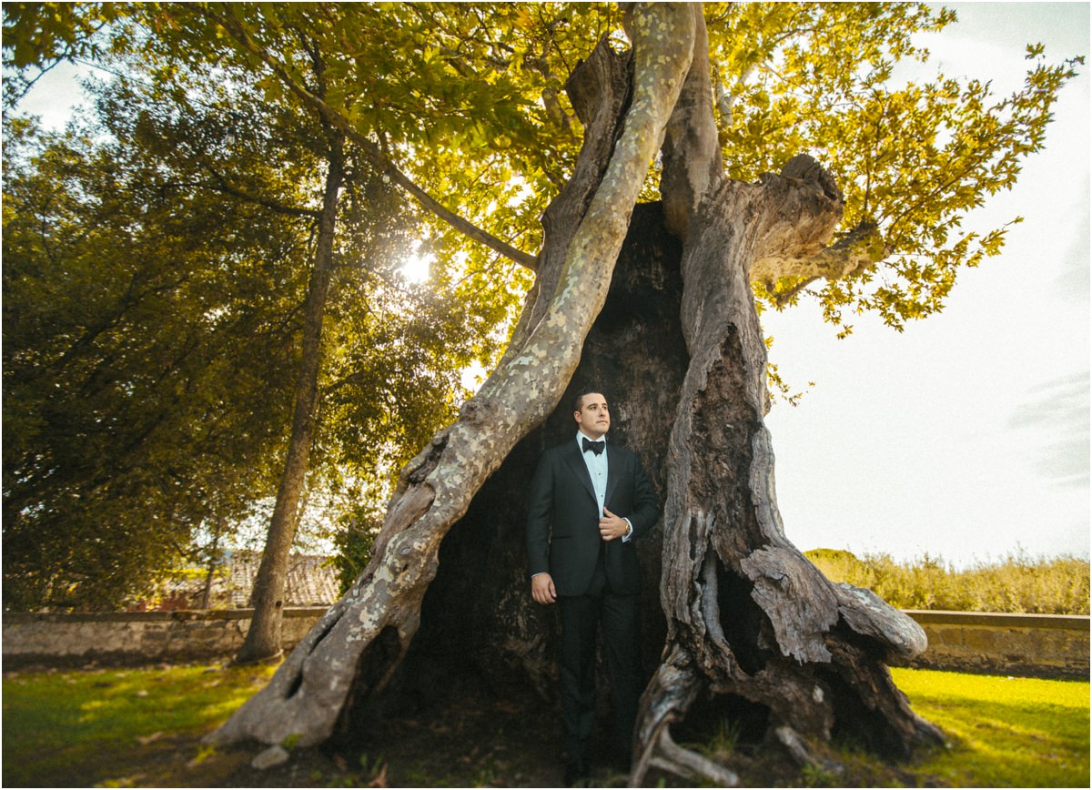 Groom Inside an Ancient Tree Groom Alessio standing inside the hollow trunk of an ancient tree in the park of Villa Grazioli, Castelli Romani