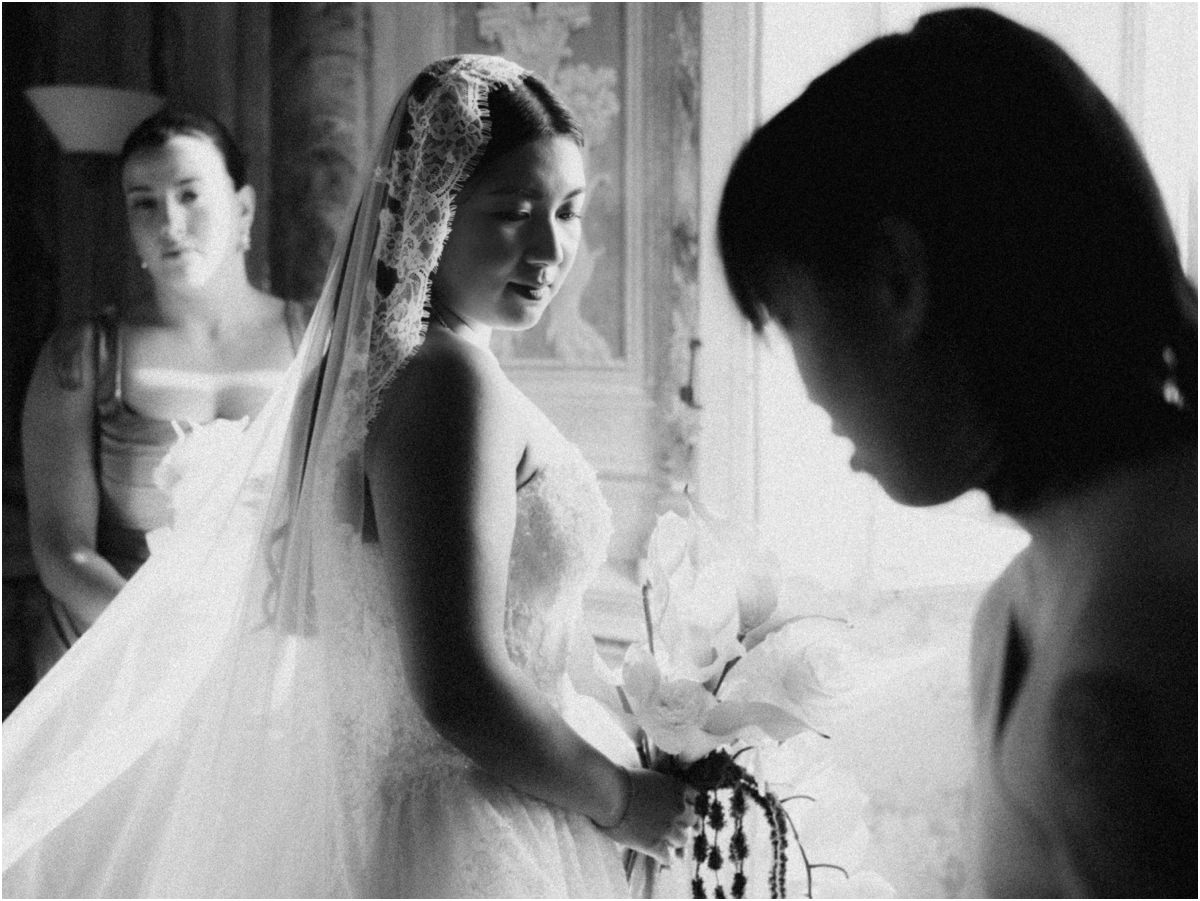 Bride with Veil and Bridesmaids Black and white photo of bride Leah with lace veil and orchid bouquet, surrounded by her bridesmaids