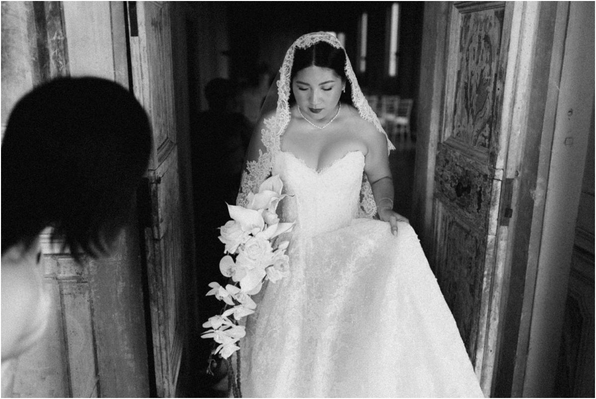 Leah at the Door Black and white portrait of bride Leah in her lace veil looking down at a doorway of Villa Grazioli