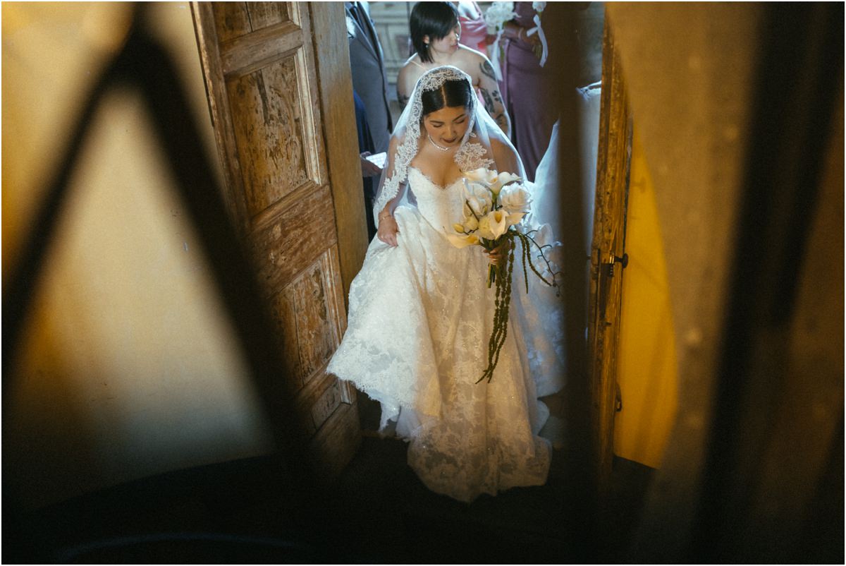 Bride Walking Through the Door Bride Leah walking through a doorway of Villa Grazioli with her bouquet, bridesmaids behind her