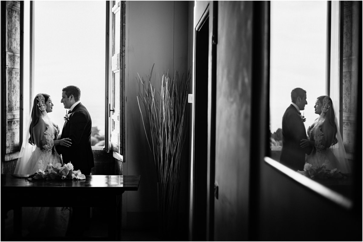 Newlyweds by the Window Black and white photo of Alessio and Leah facing each other by a window of Villa Grazioli