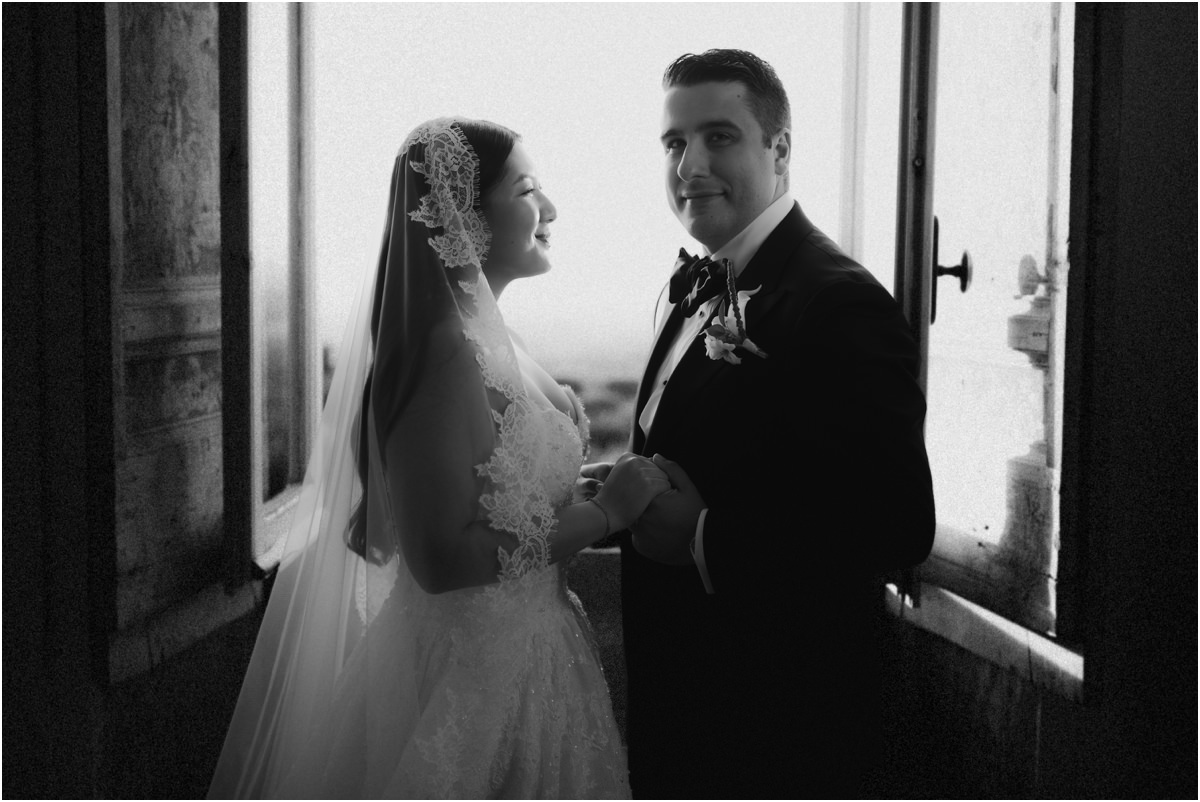 Alessio and Leah Holding Hands Black and white portrait of Alessio and Leah holding hands and smiling by the window
