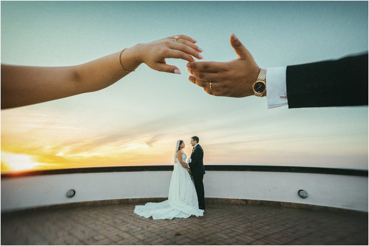Hands Reaching at Sunset Hands reaching towards each other framing Alessio and Leah on the terrace at sunset