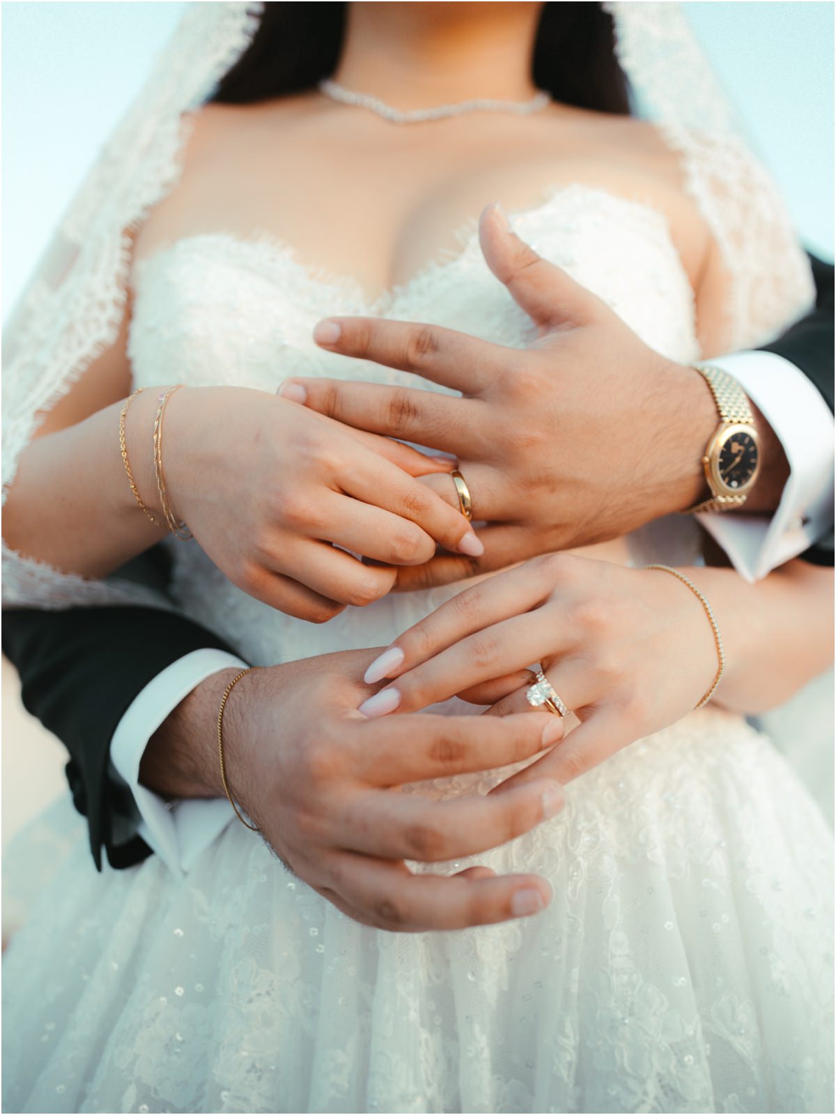 Rings and Hands Detail of Alessio and Leah's hands with their wedding rings and his gold watch on her lace dress