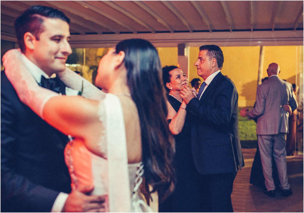 Dancing Together Alessio and Leah dancing close while guests dance behind them under the pavilion