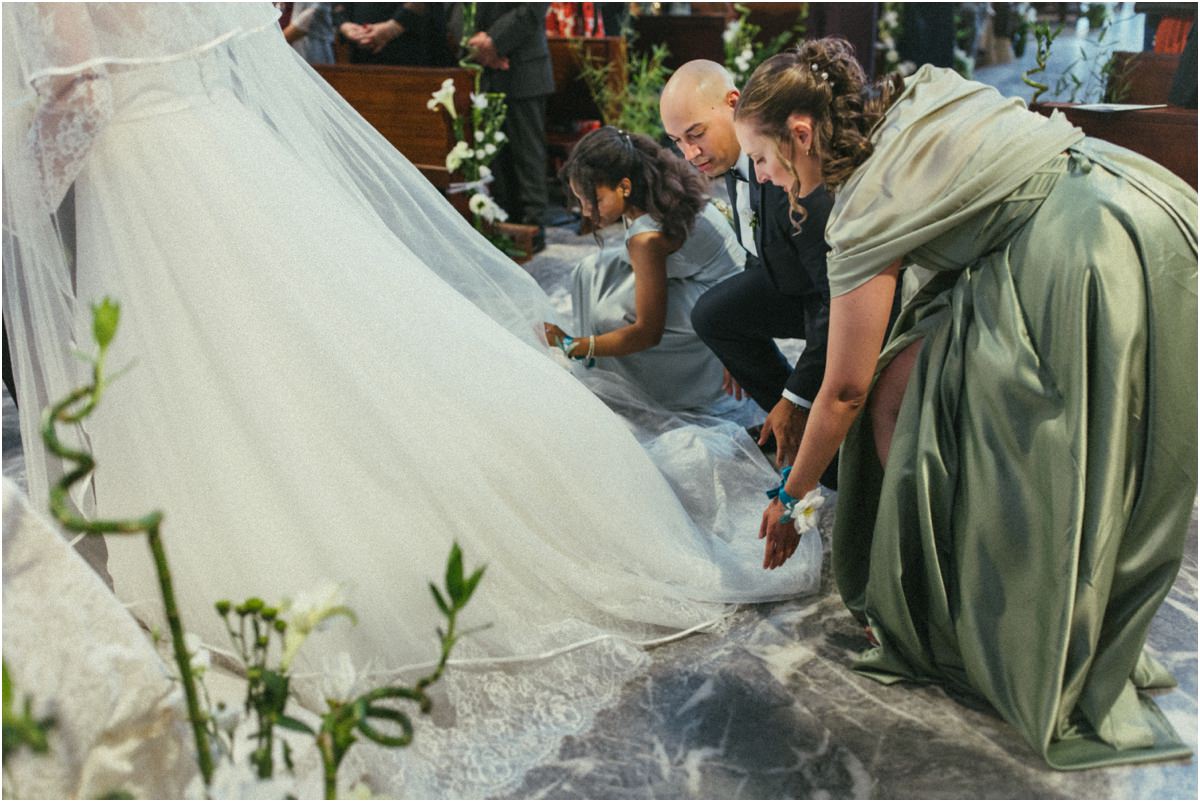 Strascico dell'abito da sposa Un'amica sistema lo strascico dell'abito della sposa all'altare